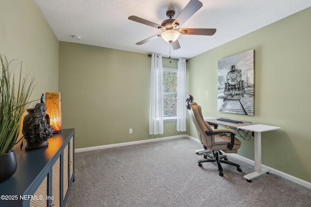 office with a textured ceiling, ceiling fan, baseboards, and carpet