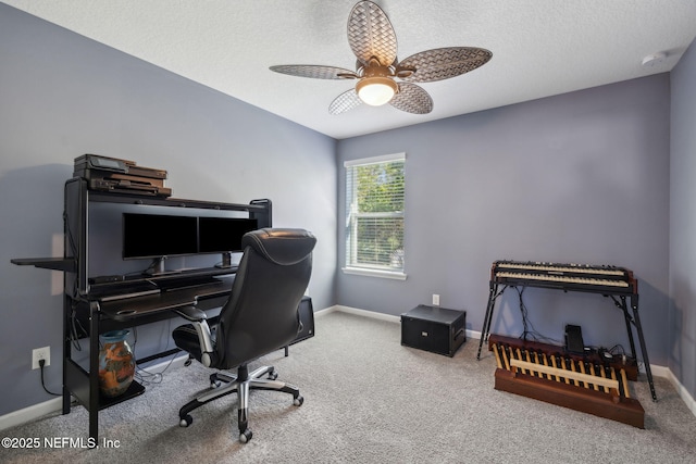 home office with baseboards, ceiling fan, carpet, and a textured ceiling