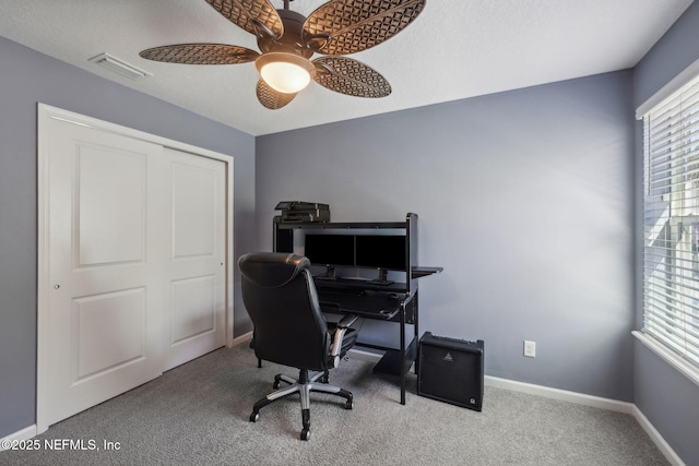 office space featuring carpet flooring, a ceiling fan, baseboards, and visible vents