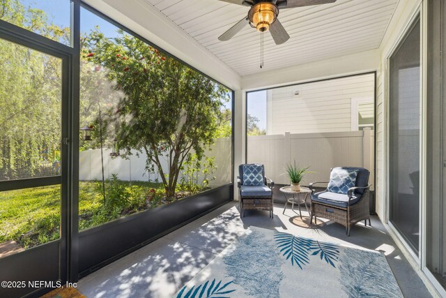sunroom / solarium with a healthy amount of sunlight and ceiling fan