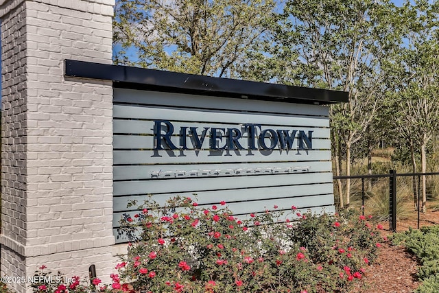 community / neighborhood sign with fence