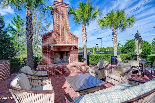 view of patio featuring an outdoor living space with a fireplace and outdoor dining space