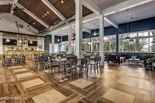 dining room with beamed ceiling, high vaulted ceiling, visible vents, and a ceiling fan