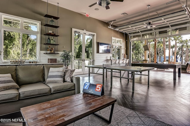 playroom featuring a ceiling fan, plenty of natural light, and visible vents