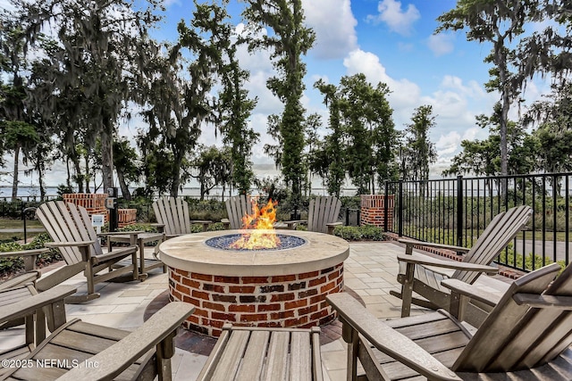 view of patio / terrace with an outdoor fire pit and fence