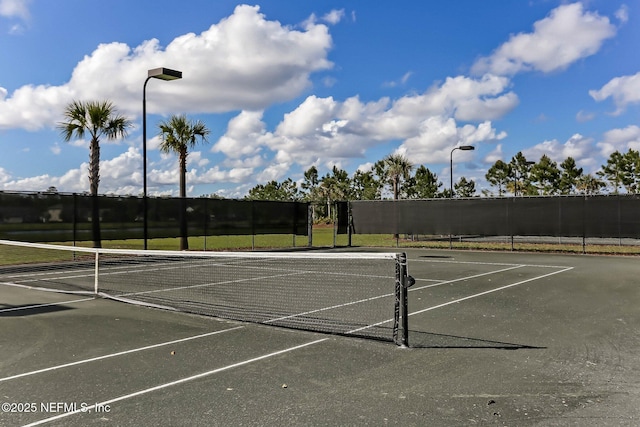 view of sport court with fence