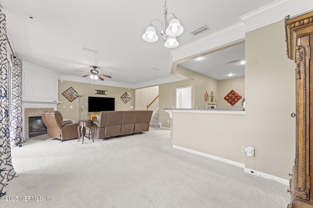 11066 Castlemain Cir, Jacksonville, FL 32256 - carpeted living area with visible vents, ornamental molding, baseboards, a high end fireplace, and ceiling fan with notable chandelier