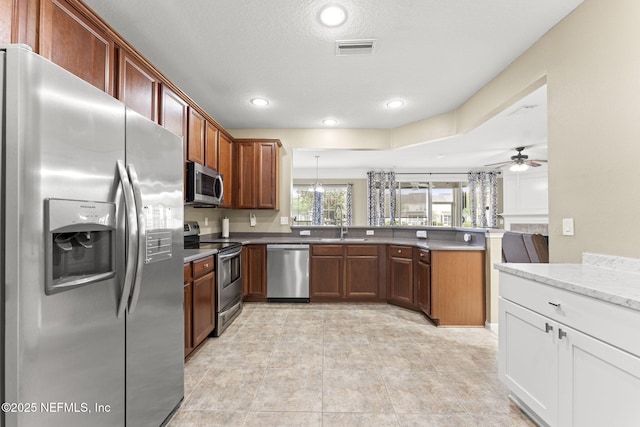 11066 Castlemain Cir, Jacksonville, FL 32256 - kitchen with visible vents, a peninsula, recessed lighting, a sink, and stainless steel appliances