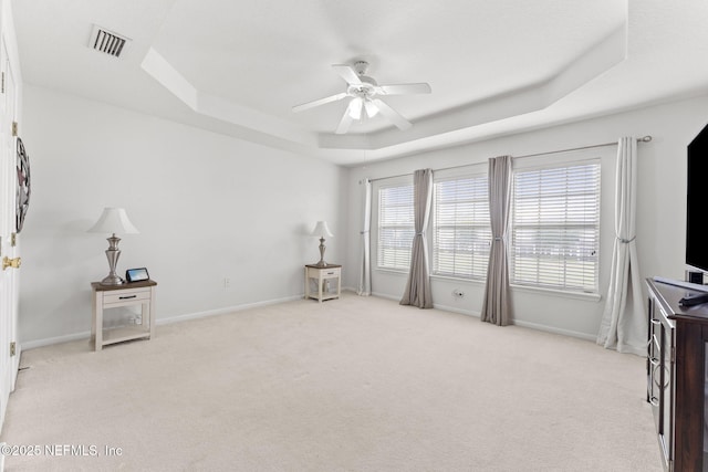 11066 Castlemain Cir, Jacksonville, FL 32256 - interior space featuring a ceiling fan, light colored carpet, visible vents, baseboards, and a tray ceiling