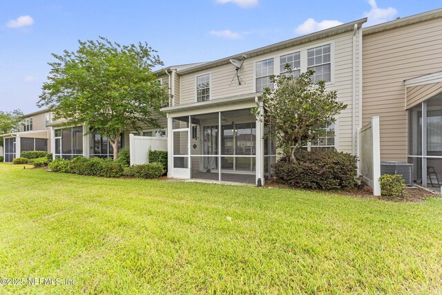 11066 Castlemain Cir, Jacksonville, FL 32256 - back of property with a lawn, a sunroom, and central AC