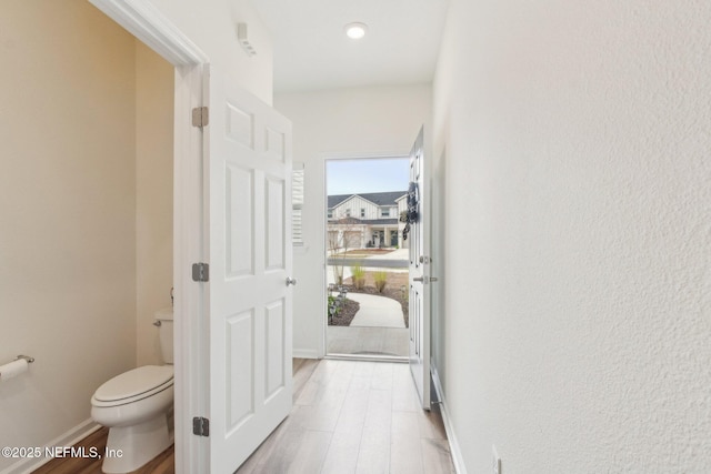 7686 Merchants Way, Jacksonville, FL 32222 - hall featuring baseboards and light wood-style flooring