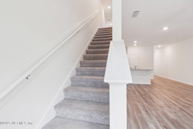 7686 Merchants Way, Jacksonville, FL 32222 - stairs featuring baseboards, visible vents, wood finished floors, and recessed lighting