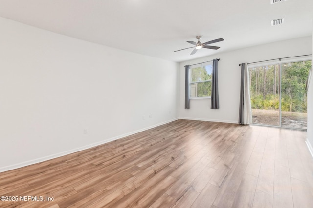 7686 Merchants Way, Jacksonville, FL 32222 - unfurnished room featuring baseboards, visible vents, light wood-style floors, and a ceiling fan