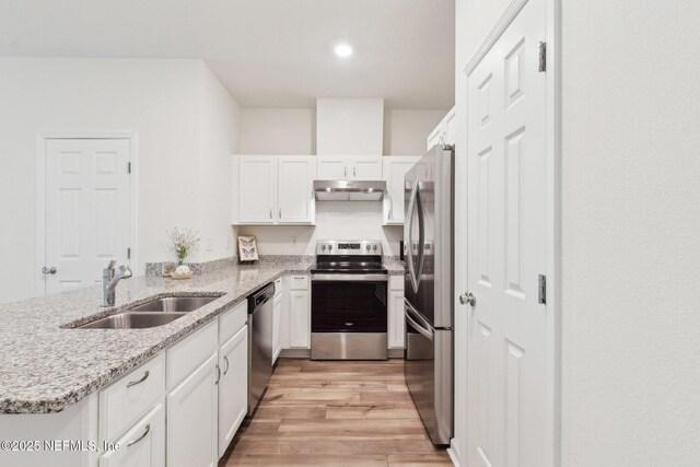 7686 Merchants Way, Jacksonville, FL 32222 - kitchen featuring white cabinets, stainless steel appliances, under cabinet range hood, a sink, and light wood-style floors