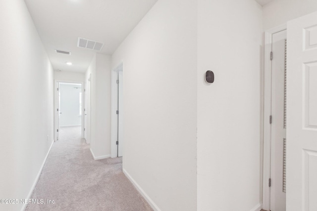 7686 Merchants Way, Jacksonville, FL 32222 - corridor featuring light carpet, baseboards, and visible vents