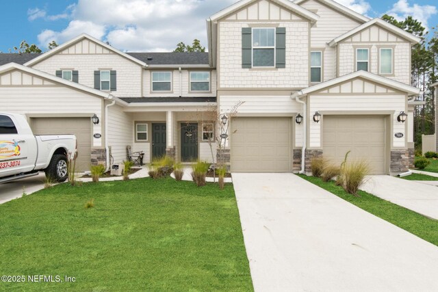 7686 Merchants Way, Jacksonville, FL 32222 - view of front facade featuring stone siding, a garage, concrete driveway, a front yard, and board and batten siding