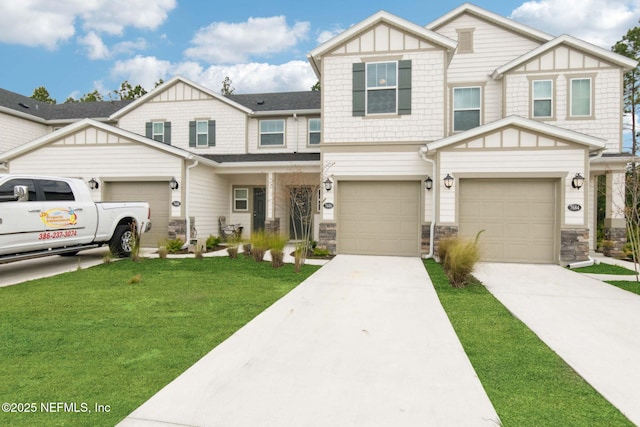 7686 Merchants Way, Jacksonville, FL 32222 - view of front of property with stone siding, a front yard, driveway, and an attached garage
