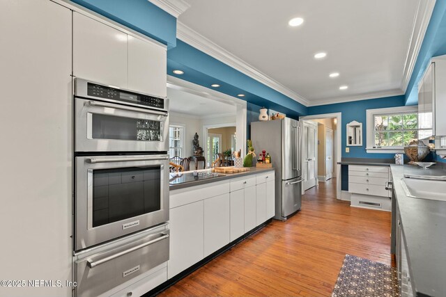 1301 Redbud Ln, Jacksonville, FL 32207 - kitchen featuring a warming drawer, stainless steel appliances, white cabinets, crown molding, and recessed lighting
