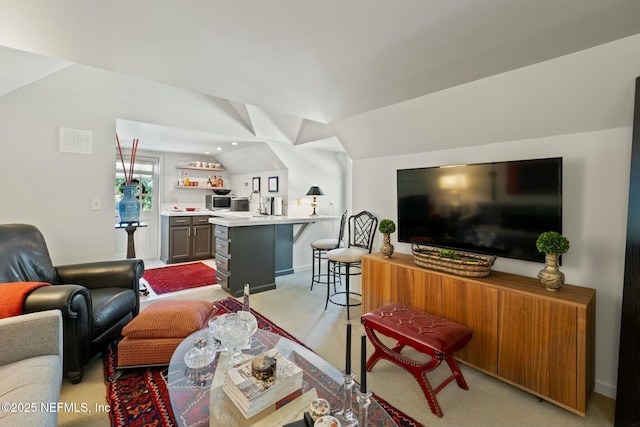 1301 Redbud Ln, Jacksonville, FL 32207 - living area with lofted ceiling, light colored carpet, bar, and baseboards