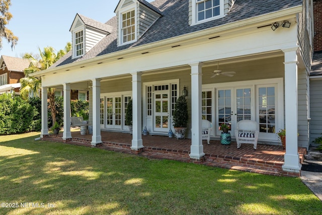 1301 Redbud Ln, Jacksonville, FL 32207 - rear view of property with french doors, a shingled roof, and a lawn