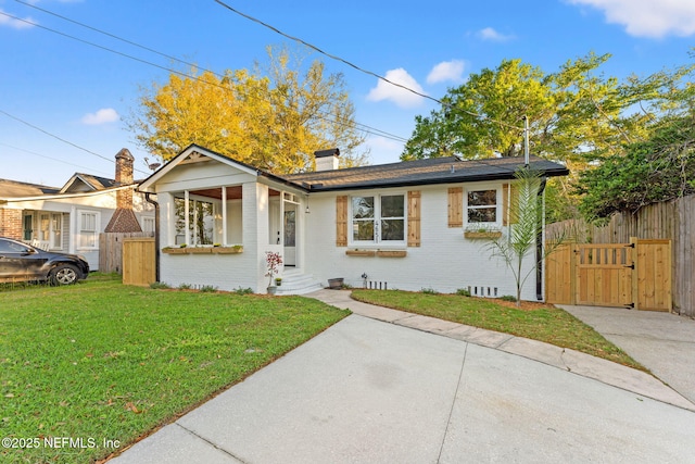 4651 Polaris St, Jacksonville, FL 32205 - bungalow featuring a gate, a chimney, fence, brick siding, and a front lawn