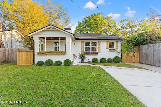 4651 Polaris St, Jacksonville, FL 32205 - view of front of home featuring a gate, a front yard, fence, and brick siding
