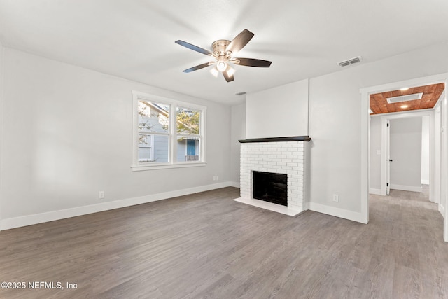 4651 Polaris St, Jacksonville, FL 32205 - unfurnished living room with a ceiling fan, wood finished floors, a fireplace, and visible vents