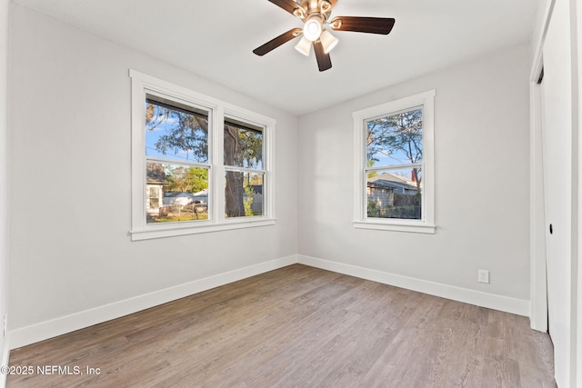 4651 Polaris St, Jacksonville, FL 32205 - spare room with baseboards, wood finished floors, and a ceiling fan