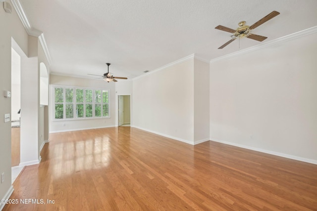 6376 Island Forest Dr Unit A, Fleming Island, FL 32003 - spare room featuring ceiling fan, ornamental molding, light wood-type flooring, baseboards, and arched walkways