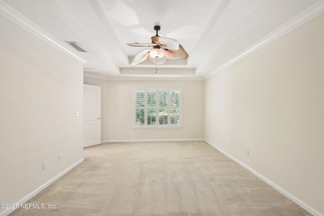 6376 Island Forest Dr Unit A, Fleming Island, FL 32003 - spare room with ceiling fan, a raised ceiling, light carpet, a textured ceiling, and crown molding
