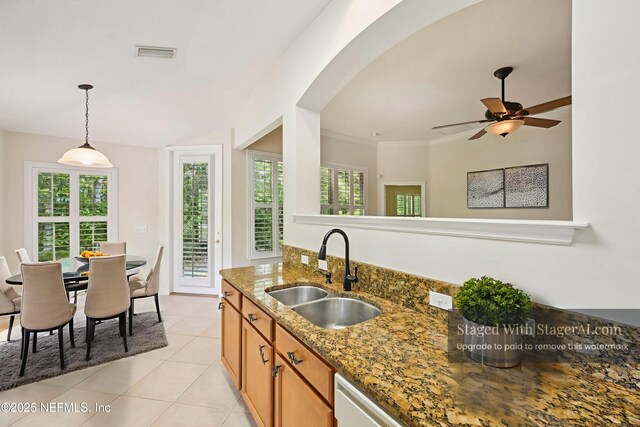 6376 Island Forest Dr Unit A, Fleming Island, FL 32003 - kitchen featuring stone countertops, light tile patterned flooring, decorative light fixtures, a ceiling fan, and brown cabinetry