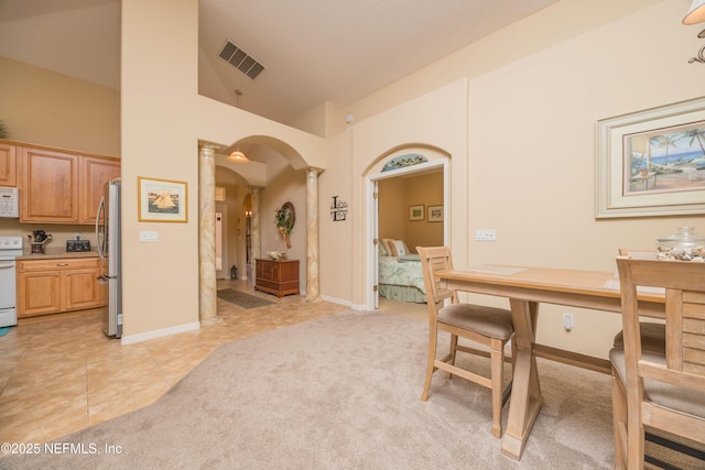 784 Crestwood Dr, Saint Augustine, FL 32086 - dining area featuring light colored carpet, ornate columns, light tile patterned floors, arched walkways, and visible vents