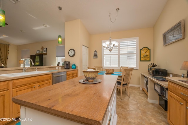 784 Crestwood Dr, Saint Augustine, FL 32086 - kitchen with a sink, a chandelier, stainless steel dishwasher, light tile patterned floors, and decorative light fixtures