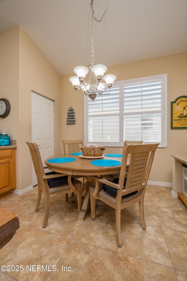 784 Crestwood Dr, Saint Augustine, FL 32086 - dining room featuring baseboards, lofted ceiling, and a notable chandelier