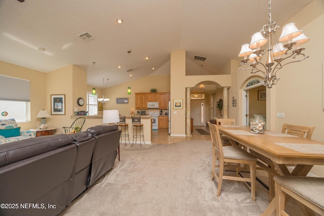 784 Crestwood Dr, Saint Augustine, FL 32086 - dining area featuring light colored carpet, a notable chandelier, visible vents, and arched walkways
