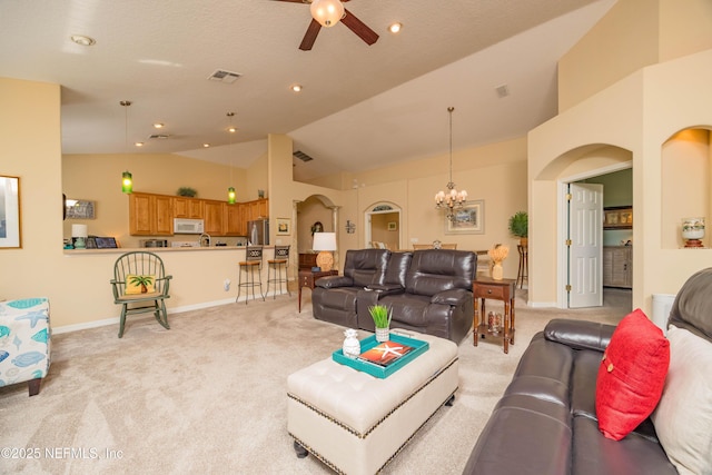 784 Crestwood Dr, Saint Augustine, FL 32086 - living room featuring baseboards, arched walkways, ceiling fan with notable chandelier, and light colored carpet