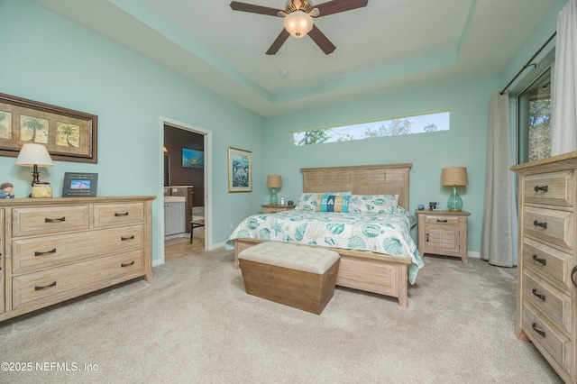 784 Crestwood Dr, Saint Augustine, FL 32086 - bedroom featuring a tray ceiling, multiple windows, and light carpet