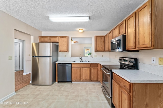 11326 Hendon Dr, Jacksonville, FL 32246 - kitchen with light countertops, a sink, stainless steel appliances, and brown cabinets