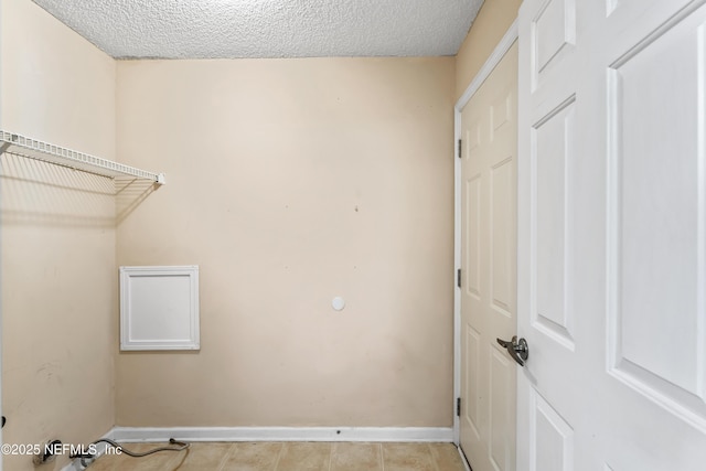 11326 Hendon Dr, Jacksonville, FL 32246 - laundry room with baseboards, a textured ceiling, and light tile patterned flooring
