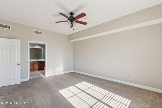 unfurnished bedroom with light carpet, baseboards, and visible vents