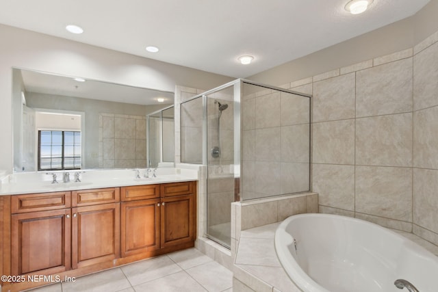 bathroom with a bath, double vanity, a sink, and a stall shower