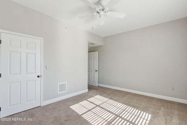 unfurnished bedroom featuring baseboards, visible vents, carpet flooring, and a ceiling fan