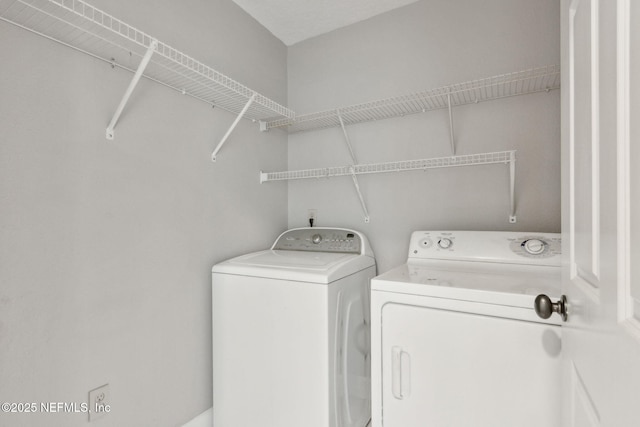 laundry area with washing machine and dryer and laundry area