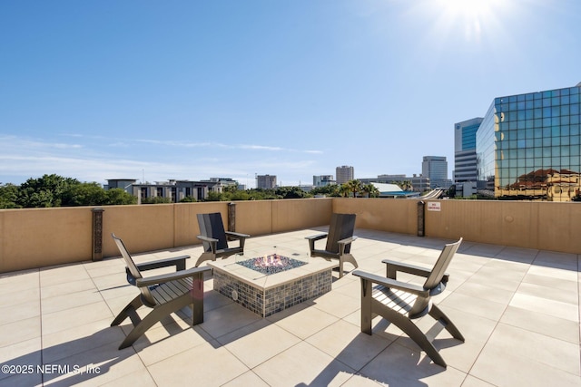 view of patio featuring a city view and a fire pit
