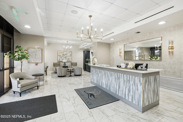 reception with an inviting chandelier and visible vents