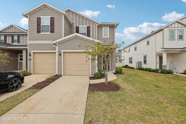 7802 Merchants Way, Jacksonville, FL 32222 - view of property featuring board and batten siding, a front yard, concrete driveway, and an attached garage
