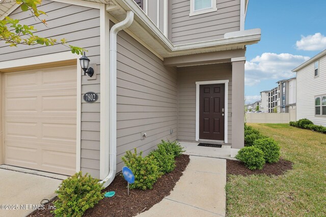 7802 Merchants Way, Jacksonville, FL 32222 - doorway to property with a garage and a yard