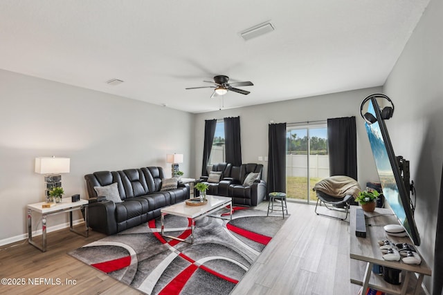 7802 Merchants Way, Jacksonville, FL 32222 - living room with wood finished floors, visible vents, baseboards, and ceiling fan