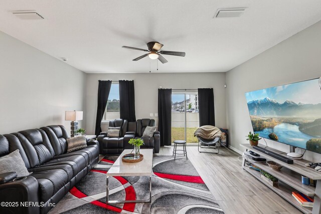 7802 Merchants Way, Jacksonville, FL 32222 - living room with baseboards, visible vents, wood finished floors, and a ceiling fan