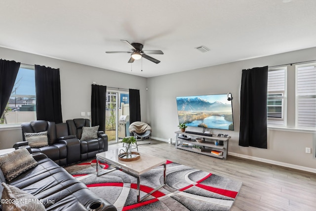 7802 Merchants Way, Jacksonville, FL 32222 - living room with baseboards, ceiling fan, visible vents, and wood finished floors